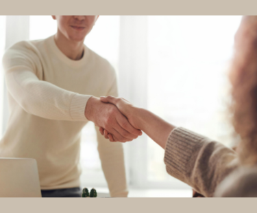Photo of young man shaking hand of hiring manager