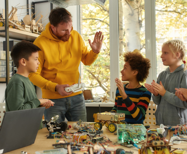 teacher and students in makers class